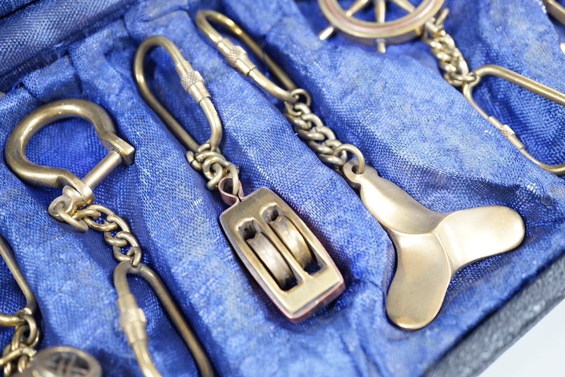 A cased set of enamelled naval buttons and similar keyrings